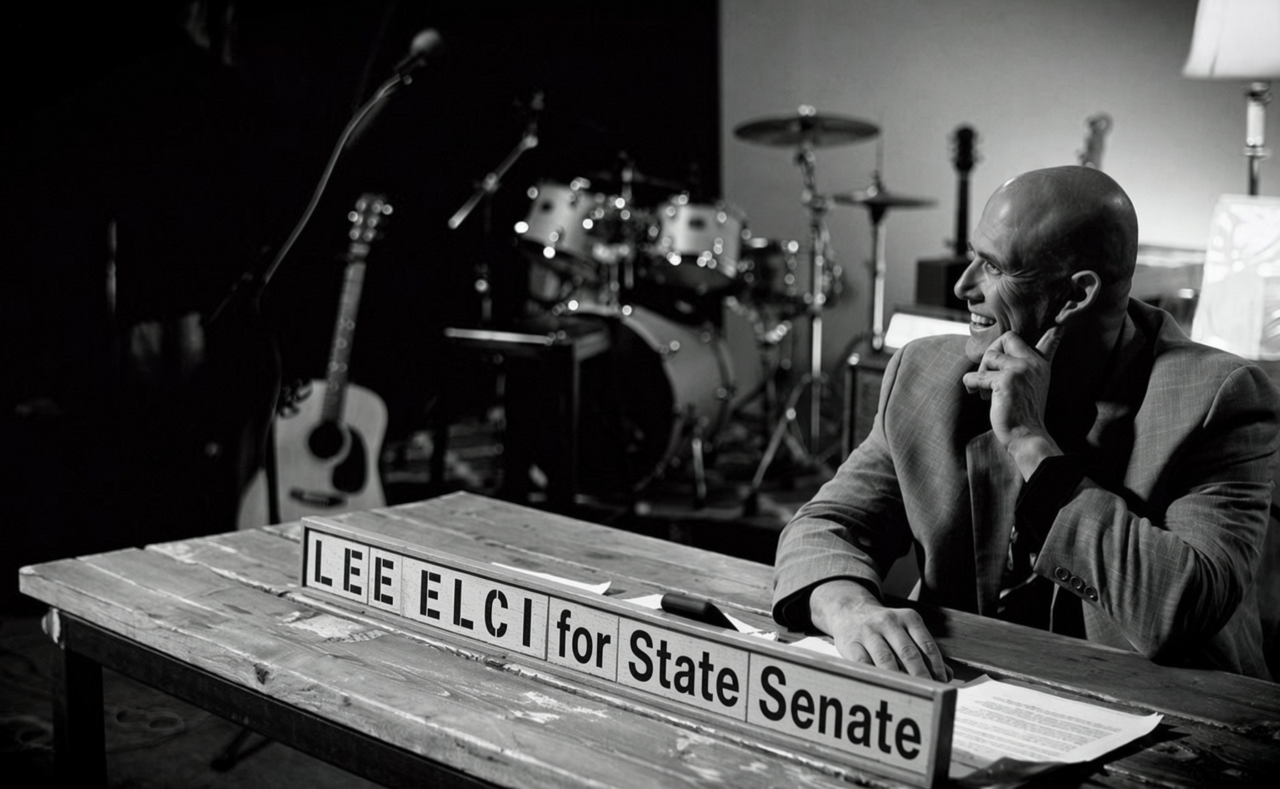 Lee Elci beside a Lee Elci for State Senate sign